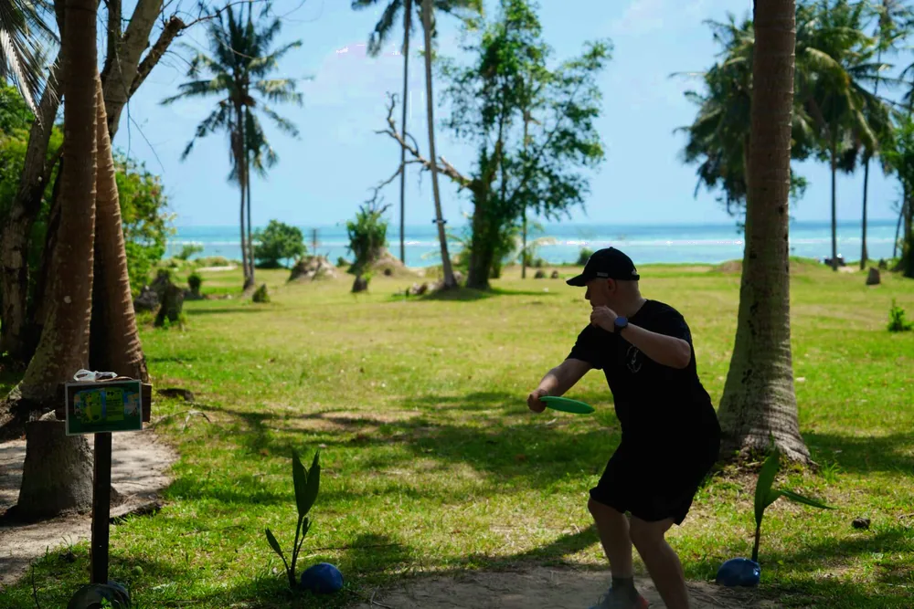 A player reaches back to drive from the tee