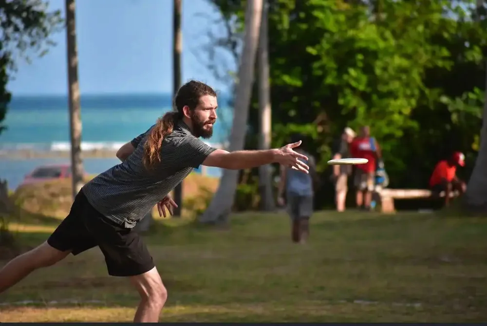 A player throws on the grass above the sea